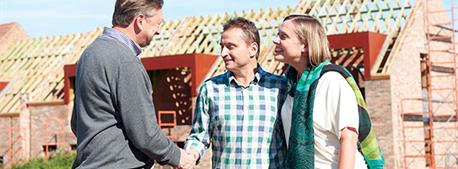 people-handshaking-in-front-of-building-house