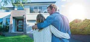 couple-in-front-of-their-dreamhouse