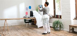 man-choosing-paint-for-wall-on-a-tablet